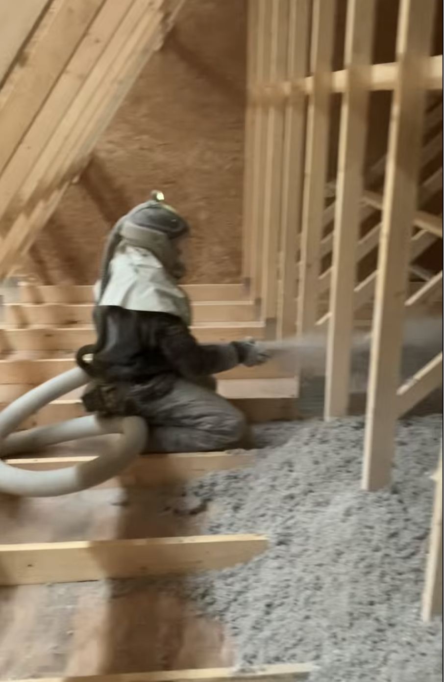 Blown-in insulation being installed in a home attic