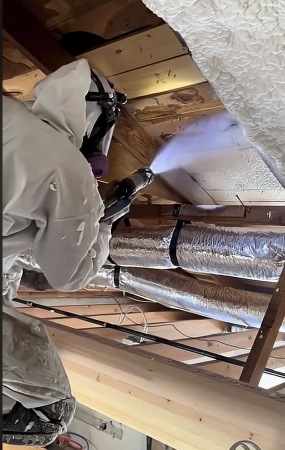 Spray foam insulation being applied in a home attic
